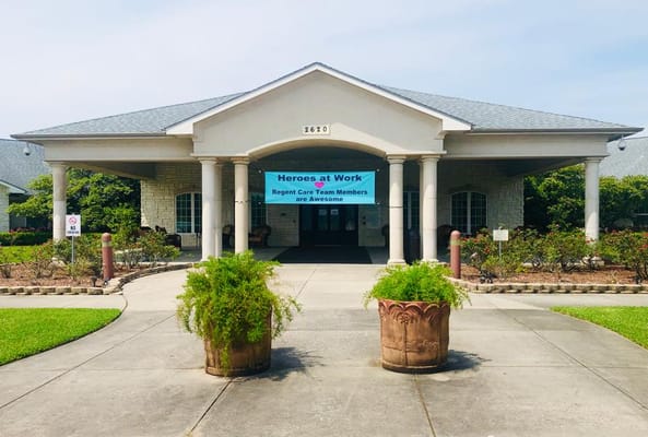 Front entrance of Regent Care Center with a banner