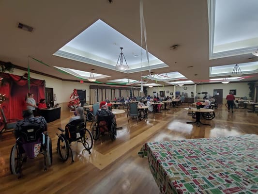 Residents enjoying a holiday event in a decorated room