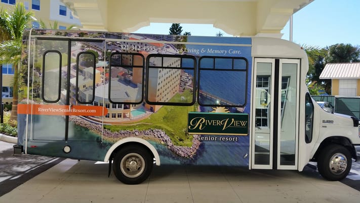 Bus featuring Riverview Senior Resort branding and contact information