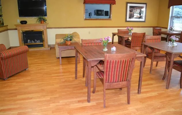 Dining area with wooden tables and striped chairs
