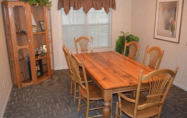 Wooden dining table with chairs and decorative cabinet in a cozy room