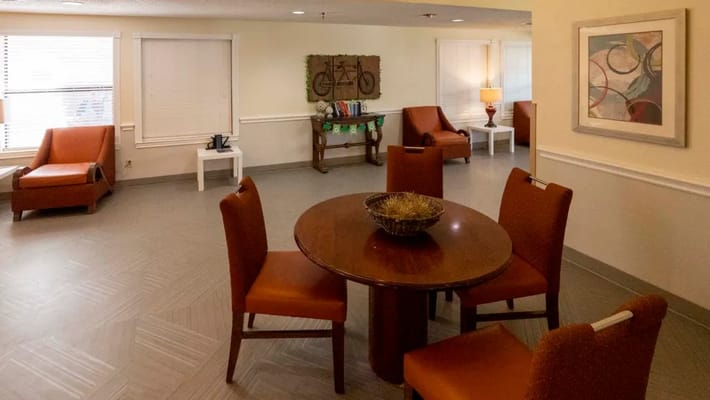 Common area with seating and tables in a bright room