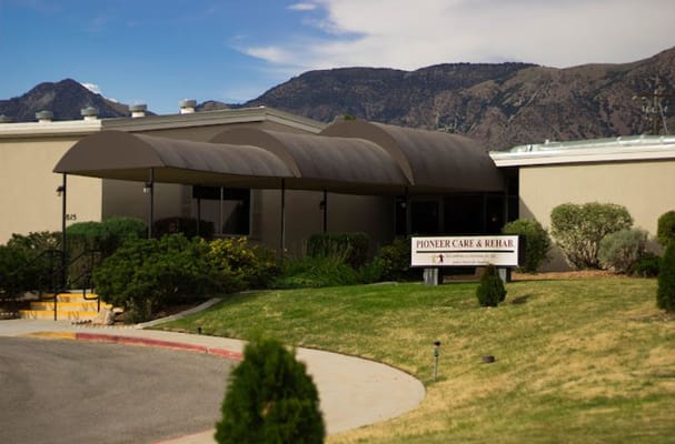 The front entrance of Sandstone Pioneer Trail with a visible sign that reads 'Pioneer Care & Rehab.'