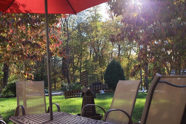 Sunny outdoor seating area with red umbrella