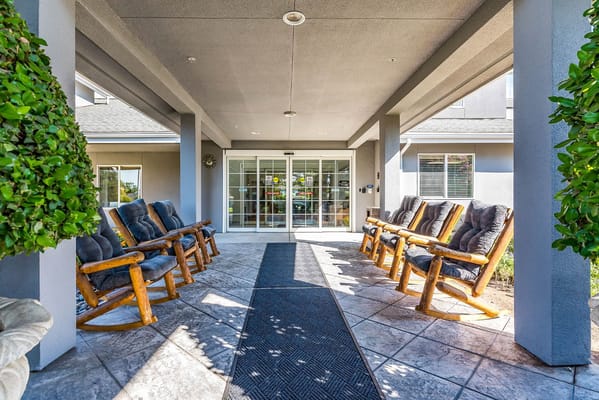 Outdoor seating area with rocking chairs at the entrance