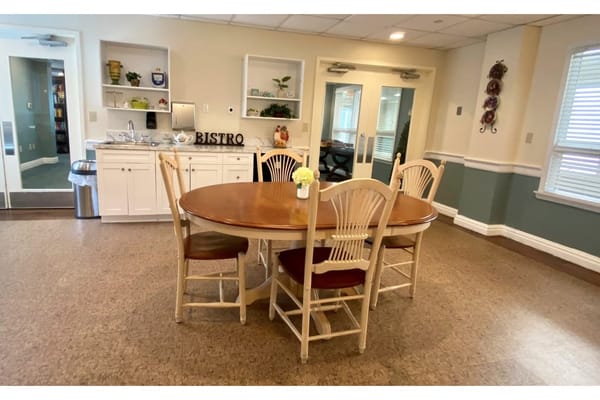 Cozy bistro dining area with wooden table and chairs