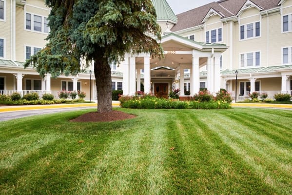Well-maintained entrance with landscaping at Sunrise of Pikesville