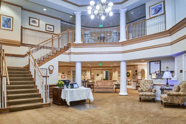 Welcoming lobby with staircase and seating area