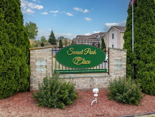 Sign of Sunset Park Place with greenery