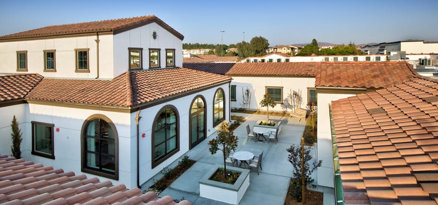 Aerial view of the courtyard with tables and trees at Temecula Memory Care.