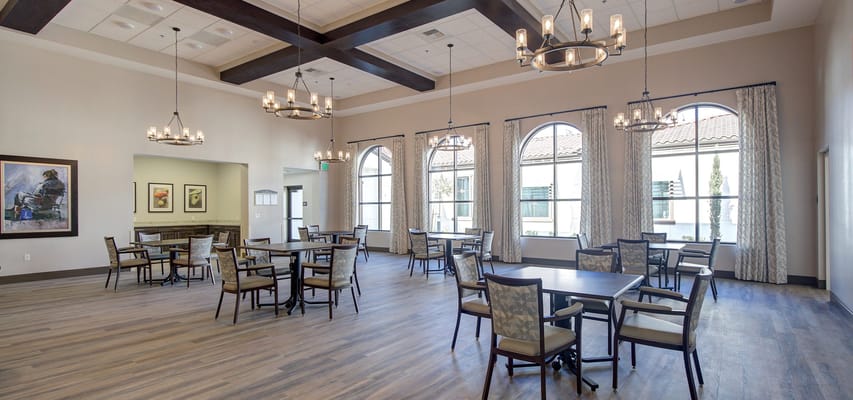 Spacious common area with tables and chairs in Temecula Memory Care