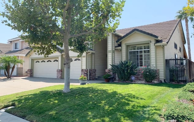 Front view of the Terrace View Assisted Living facility with green lawn and trees.