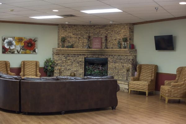 Interior common area with seating and a fireplace