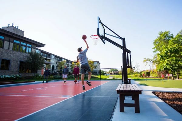Residents playing basketball on an outdoor court