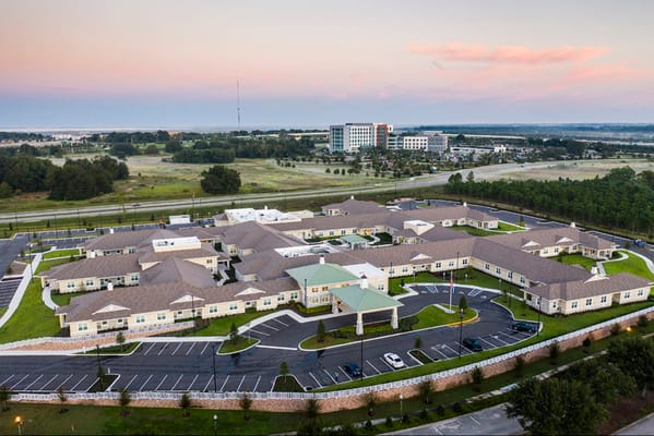 Aerial view of The Club at Lake Gibson surrounded by greenery and parking spaces.