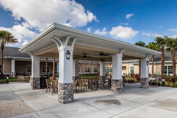 Covered outdoor seating area with tables and chairs