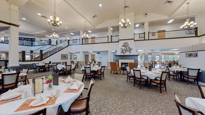 Dining area with elegantly set tables and chandeliers