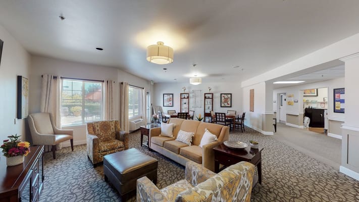 Living room area with comfortable seating and dining tables.