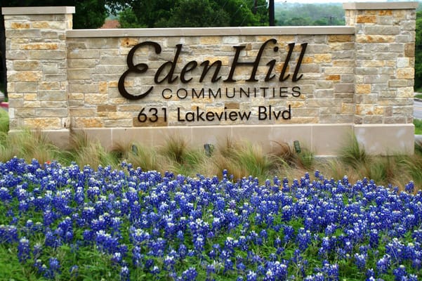 Sign for EdenHill Communities at 631 Lakeview Blvd, surrounded by bluebonnet flowers.