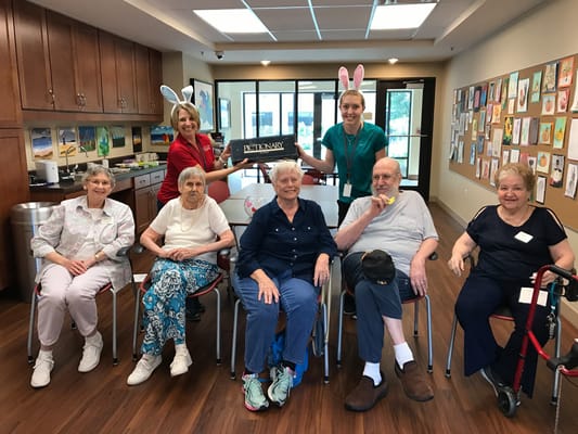 Residents and staff participating in a game night at a senior living facility.