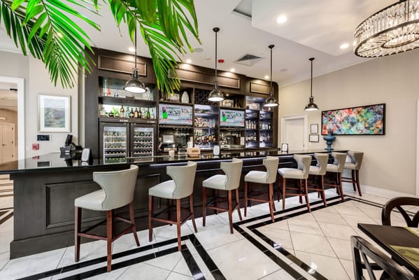 Interior view of the bar area featuring high chairs and a drink display