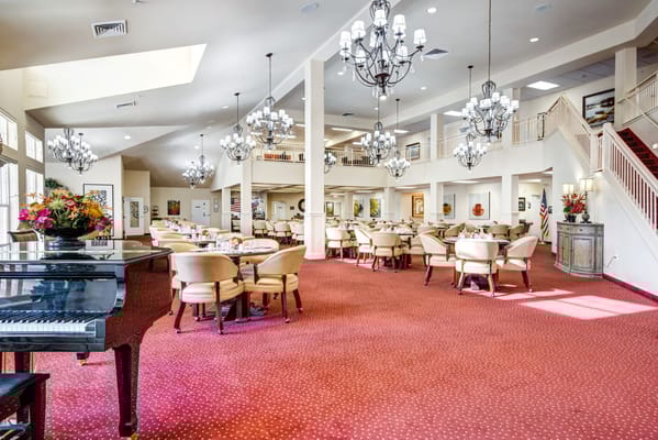 Spacious dining area with chandeliers and piano