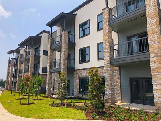 Modern building exterior with stone accents and balconies