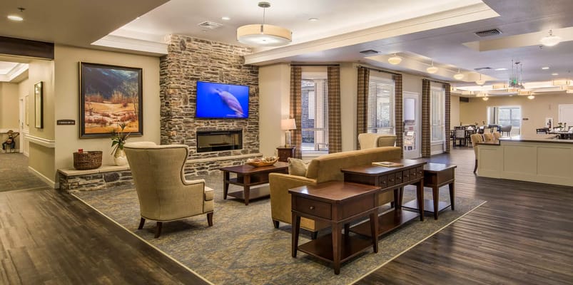 Cozy living room with seating and a stone fireplace
