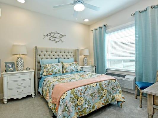 Stylish bedroom with floral bedding and natural light