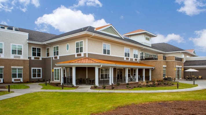The exterior of The Residences at Greer, featuring a landscaped patio and modern architecture.