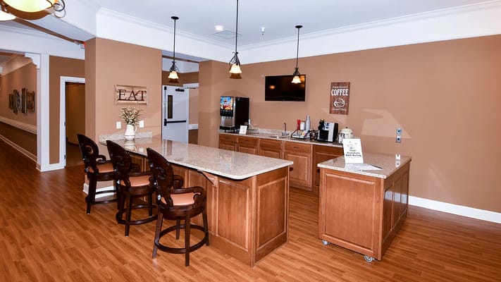 Cozy kitchenette area with seating and coffee station.