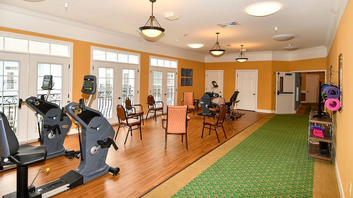 Exercise room with fitness equipment and seating area