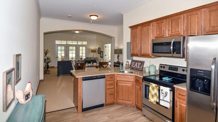 View of a kitchen and living area in a senior living facility