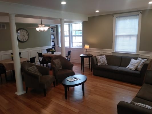 Common area with seating and tables in a bright room