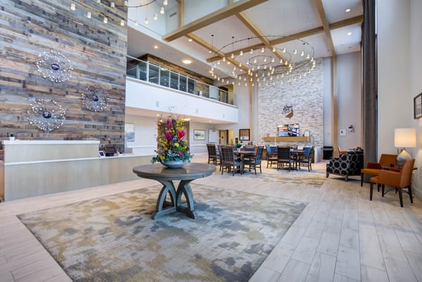Spacious lobby featuring modern decor and a floral arrangement