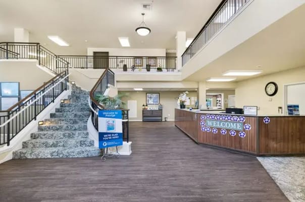 Welcoming lobby with a reception desk and stairs