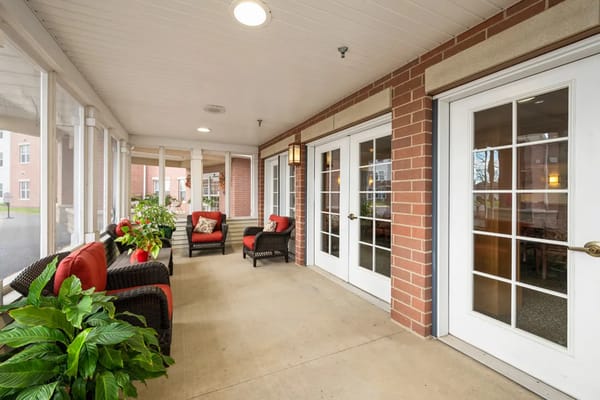 Outdoor porch with seating and plants at Trustwell Living.