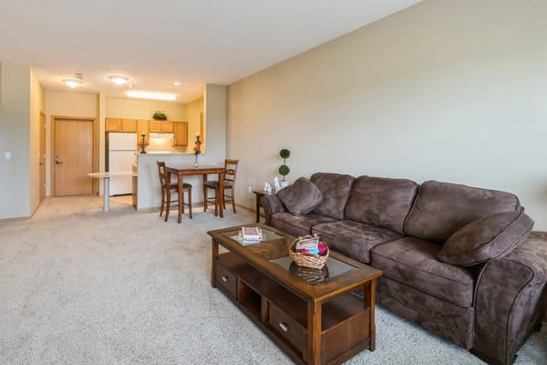Spacious living room with a couch and dining area