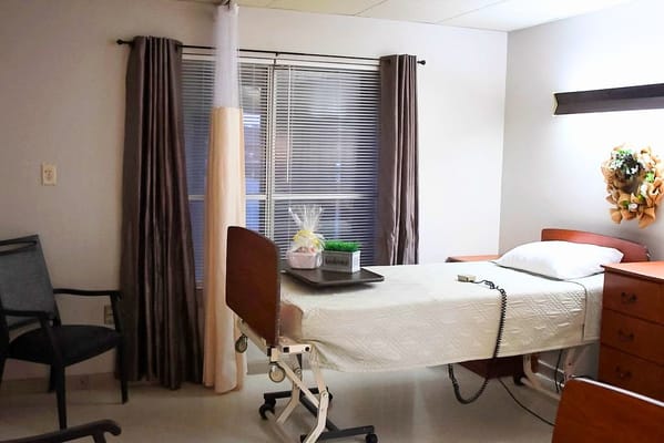 A resident room with a bed and seating