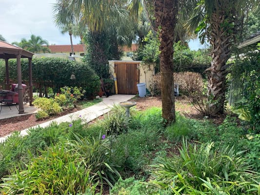 Lush garden with greenery and a gazebo at Villa Palms