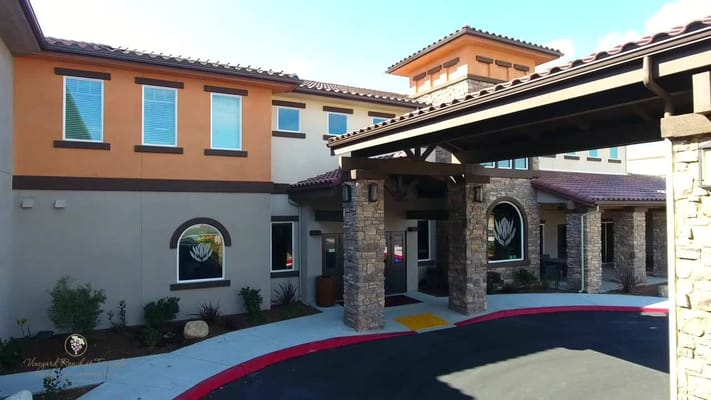 Main entrance of Vineyard Ranch at Temecula with stone and stucco facade.