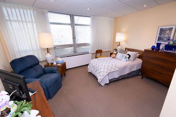 Cozy resident room with a bed and chair