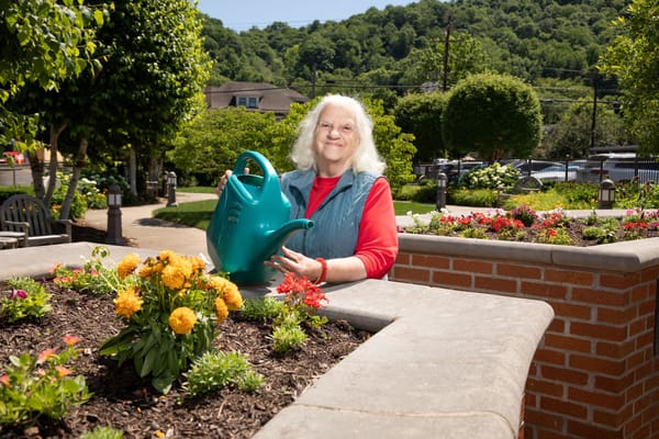 Resident gardening in a vibrant outdoor area