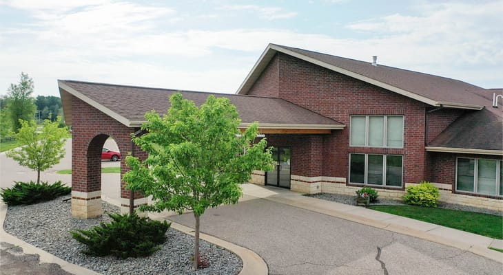 View of the entrance with green trees and building facade.