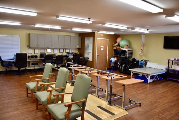 Therapy room with exercise equipment and chairs
