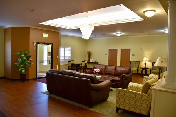 Living room with seating and decor in Winters Park Nursing and Rehabilitation Center.