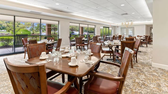 Spacious dining room with wooden tables and chairs