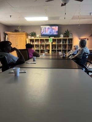 Residents watching a movie in a common area