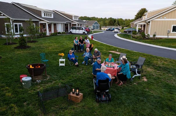 Residents enjoying an outdoor gathering around a fire pit