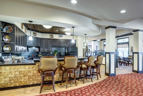 Lounge with bar stools and modern kitchen area